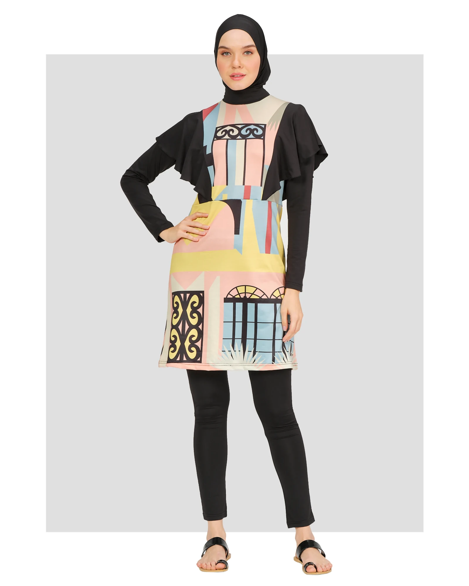Model wearing abstract print modest swimsuit set front view with black hijab.