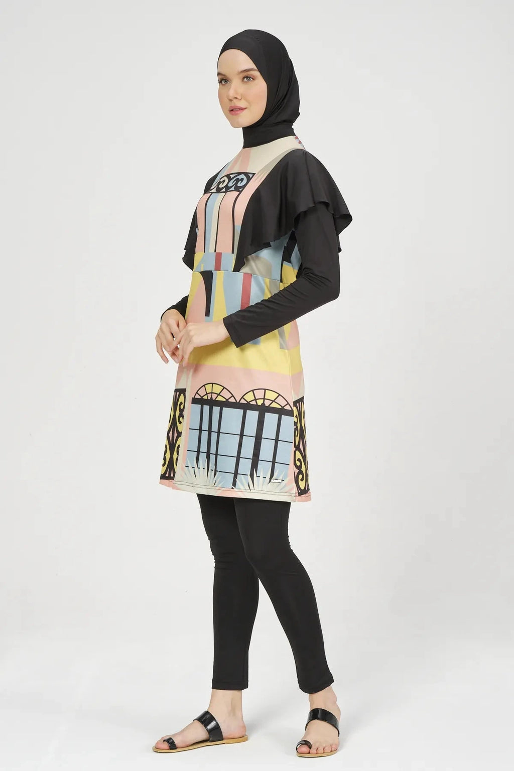 Model wearing abstract print modest swimsuit set side right view.