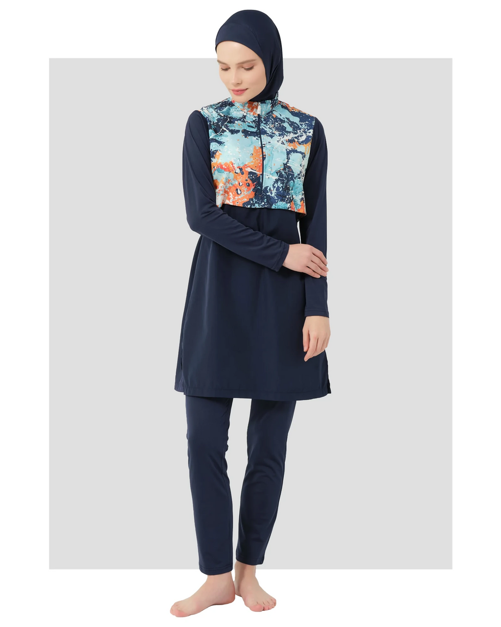 Model wearing navy burkini with abstract print top, front view.
