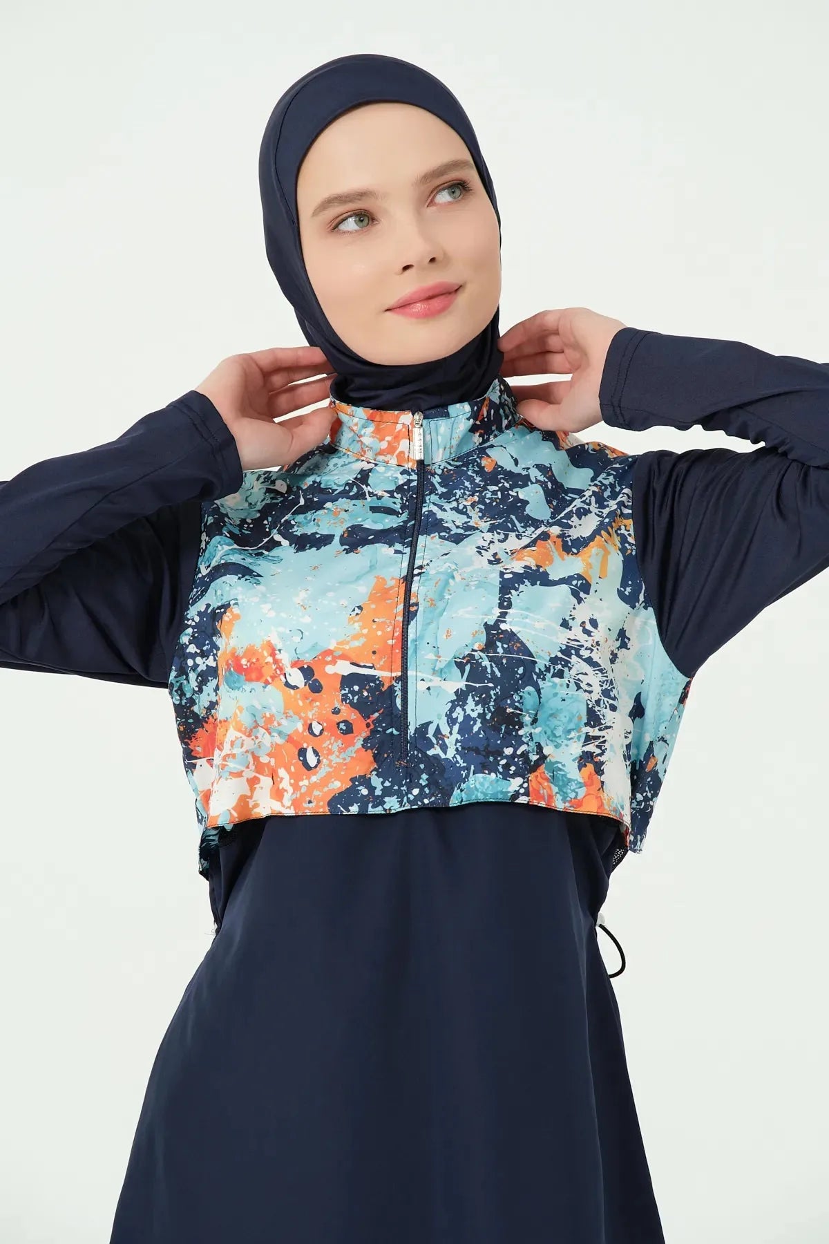 Close-up of navy burkini top with abstract print and half-zip.