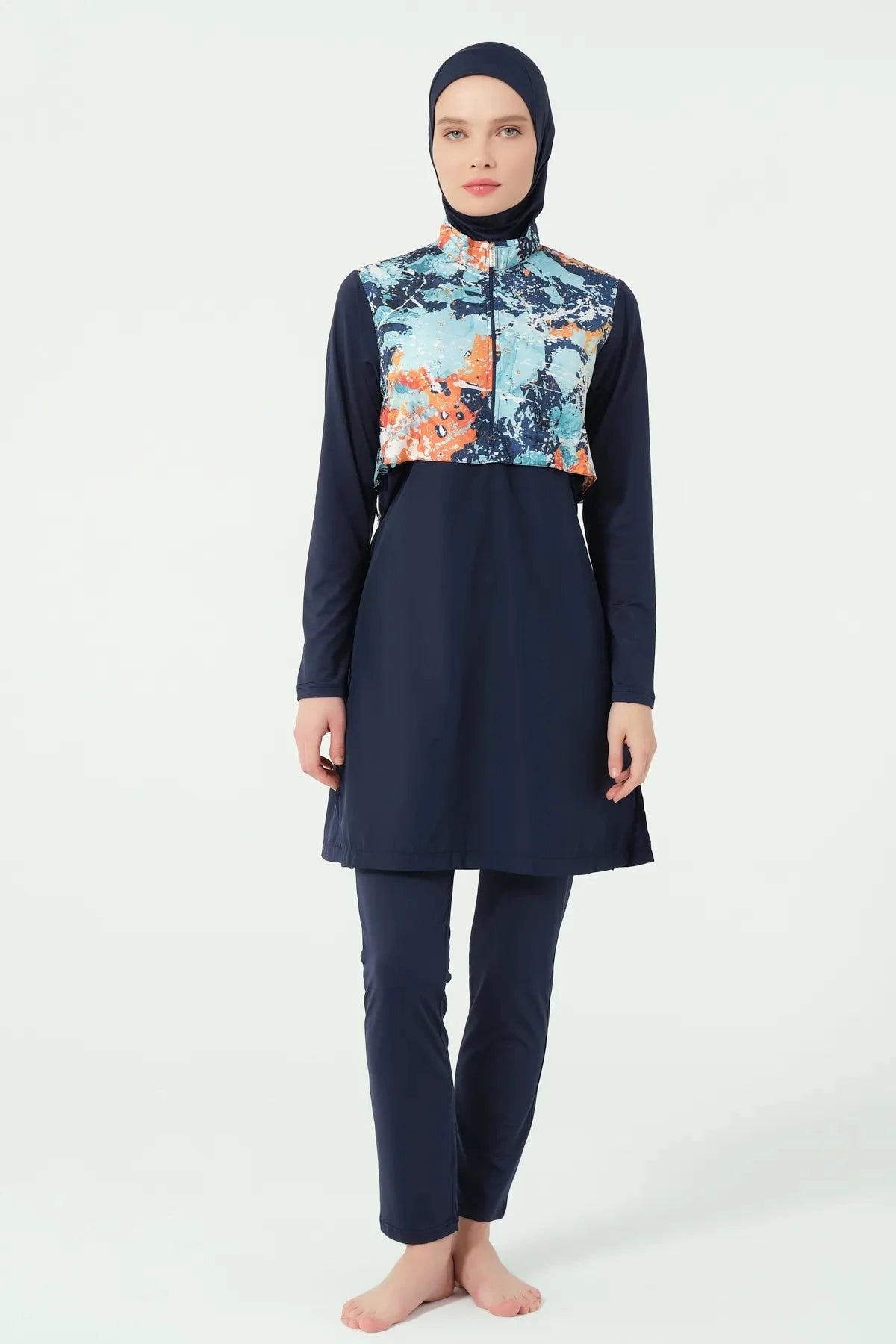 Model in navy burkini with abstract print top, full body front.