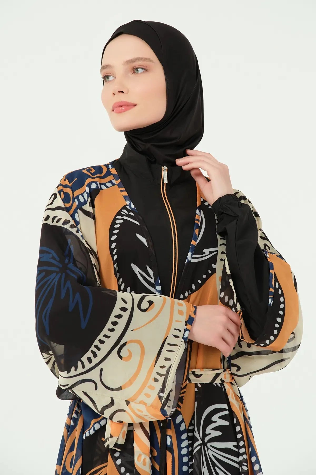 Close-up of black hijab and printed kimono over black tunic.