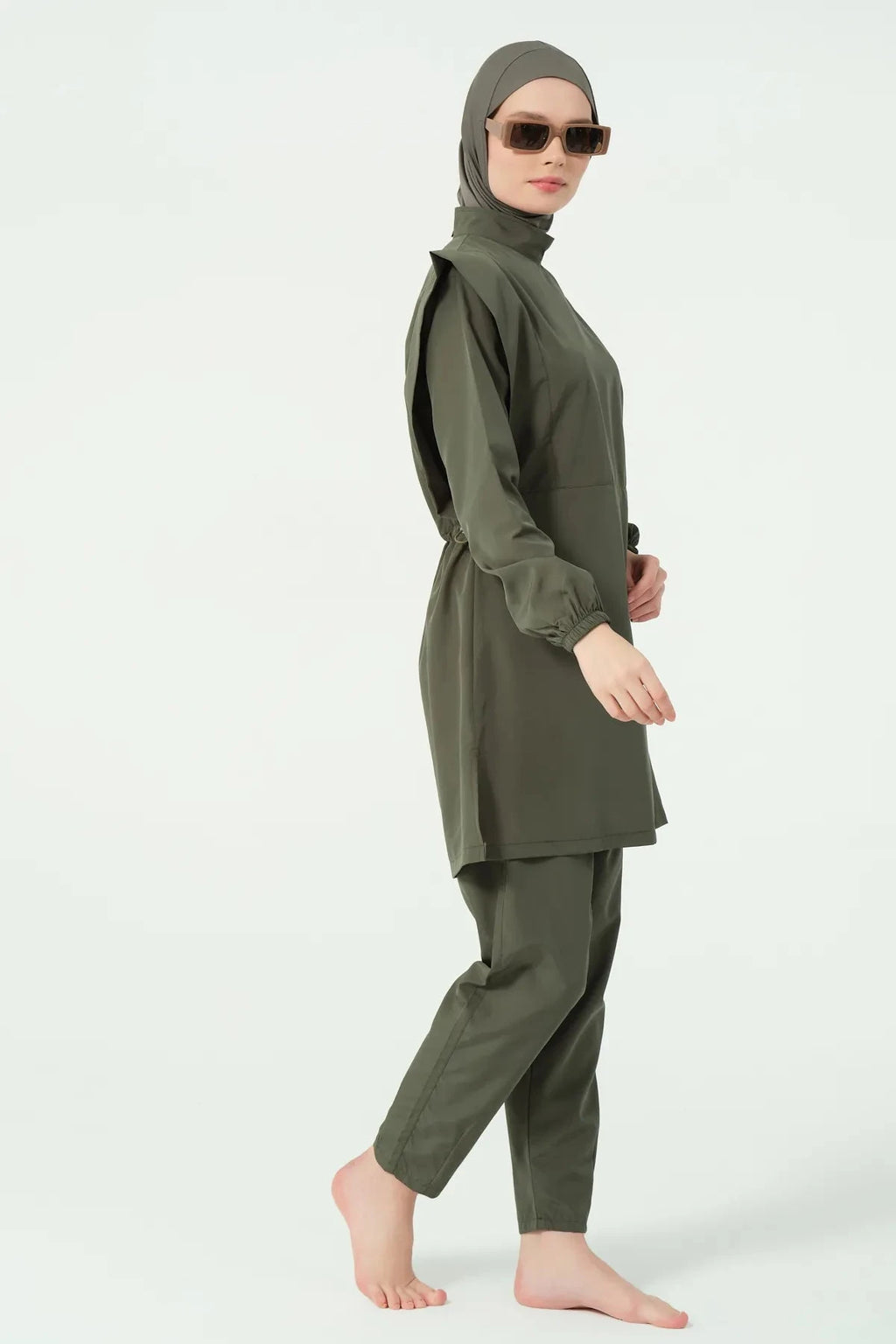 Khaki modest swimsuit set side profile with model walking.