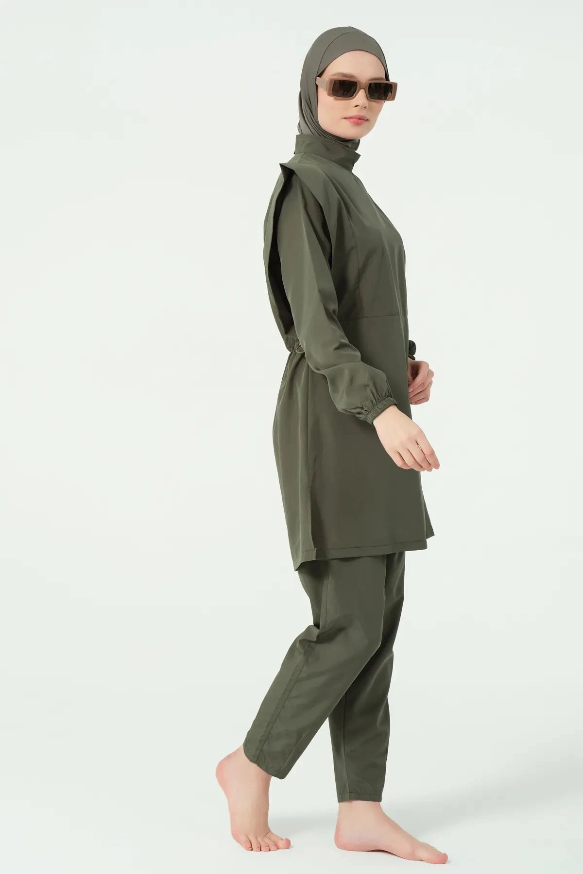 Khaki modest swimsuit set side profile with model walking.