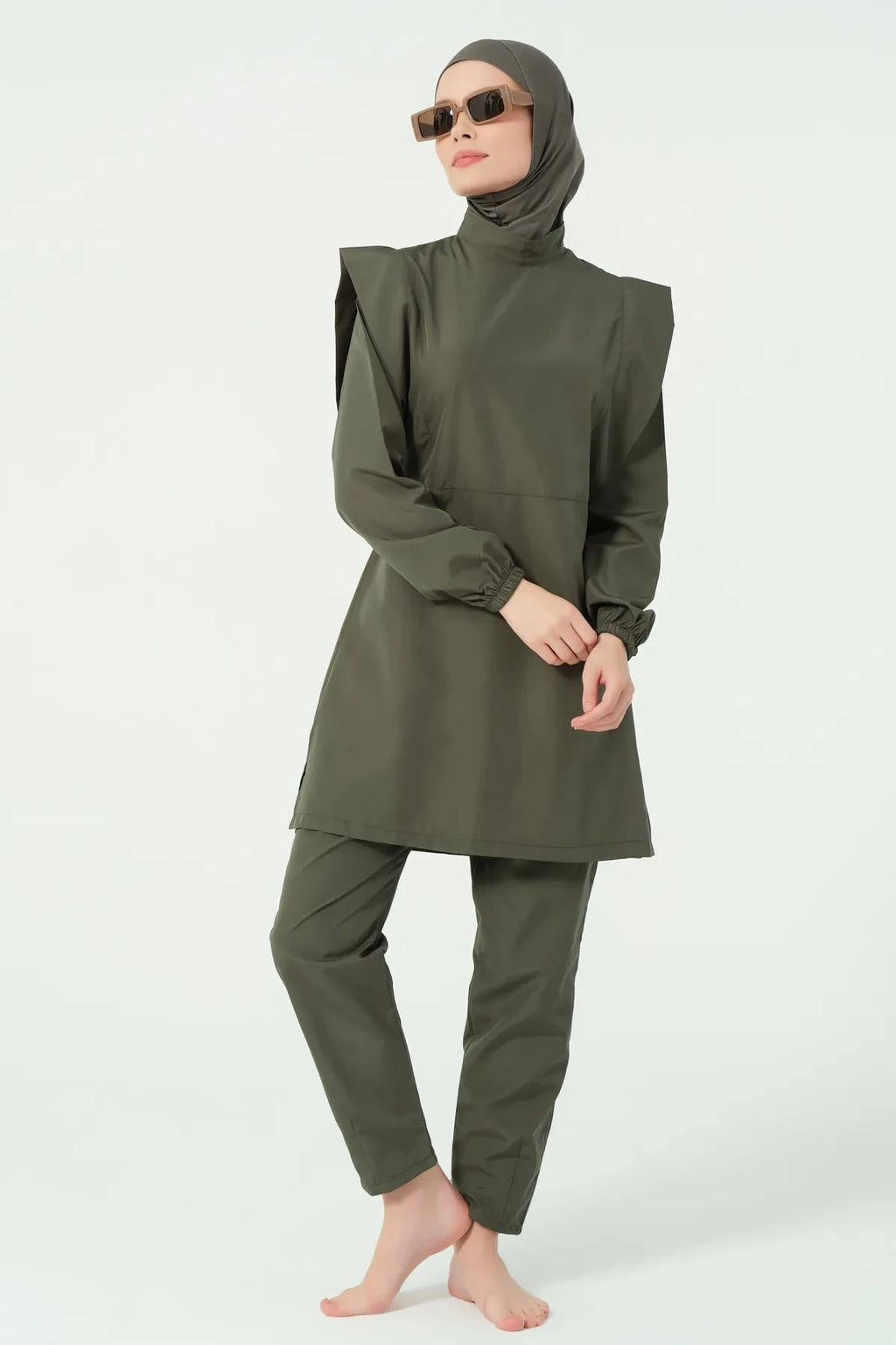 Khaki modest swimsuit set angled pose with model wearing sunglasses.