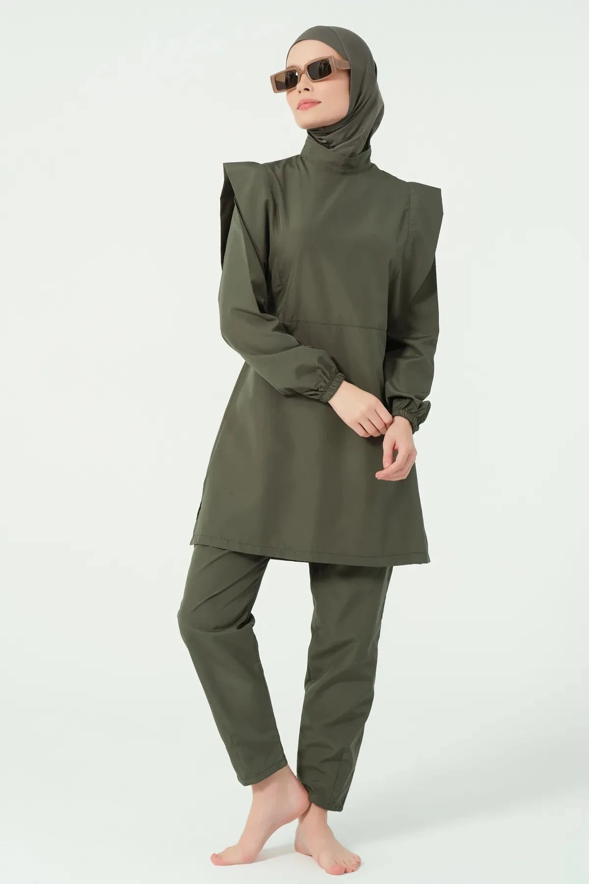 Khaki modest swimsuit set angled pose with model wearing sunglasses.