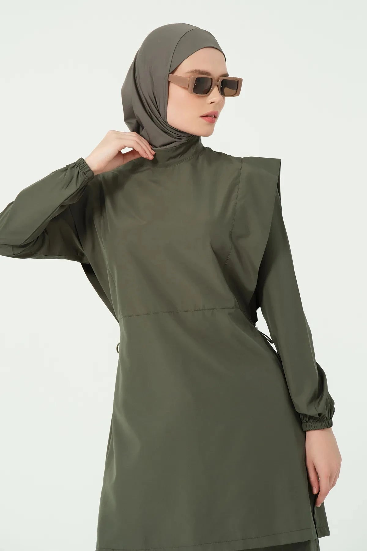 Close-up of khaki modest swimsuit collar and shoulder detail.