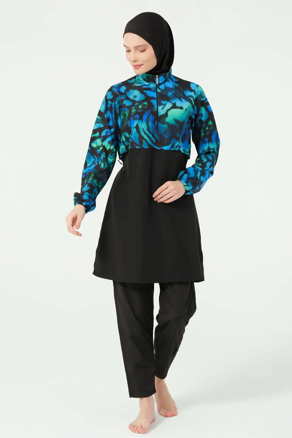 Model wearing burkini tunic, jogger pants, and black hijab, front view.