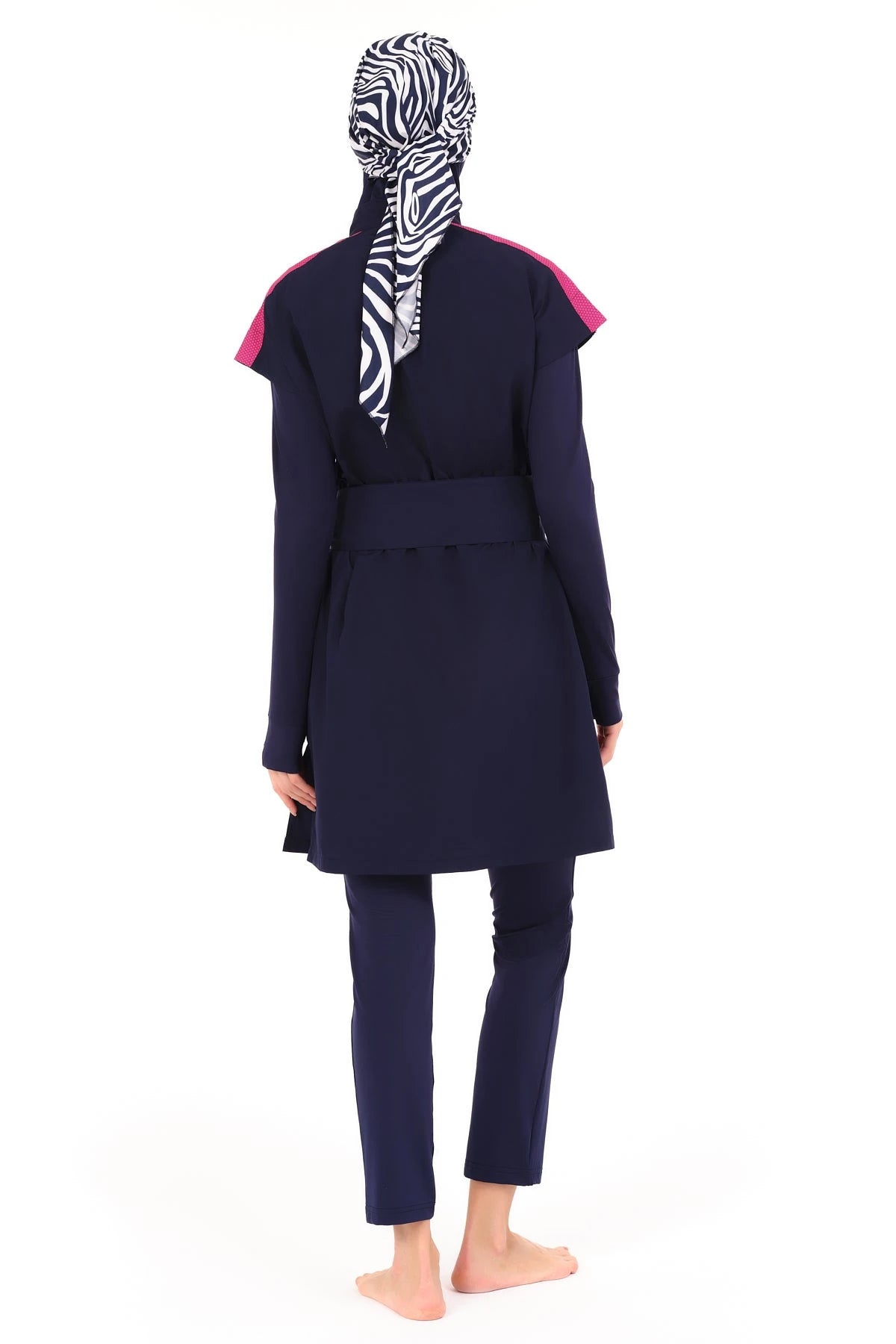 Model in navy burkini set with zebra print hijab, back view.