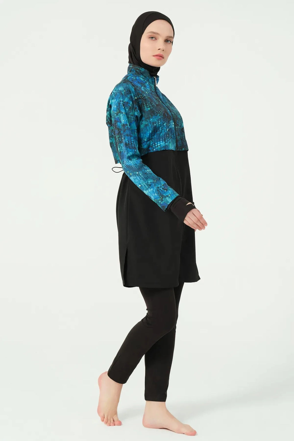 Teal and black hijab swimwear set side view, model walking.