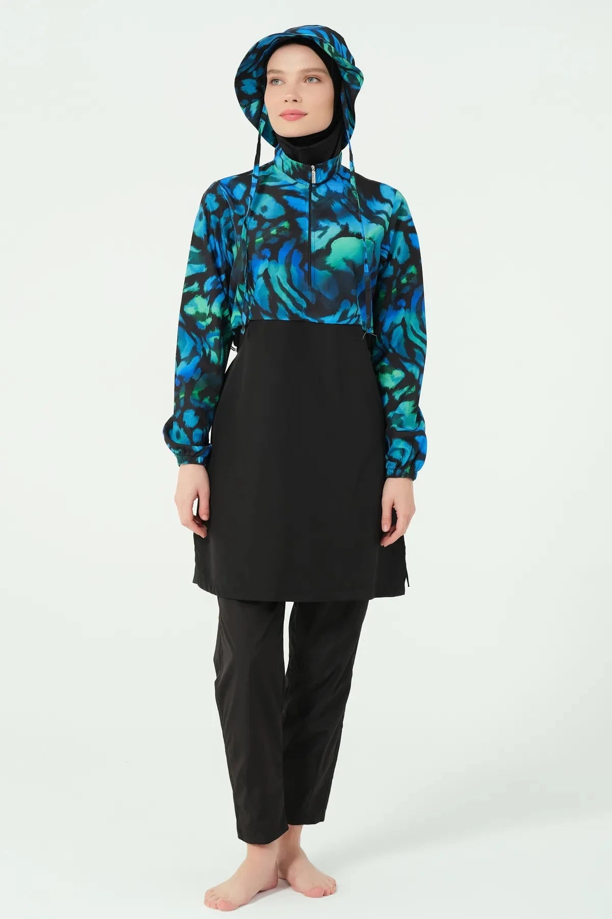 Front view of woman wearing blue and green abstract print burkini.