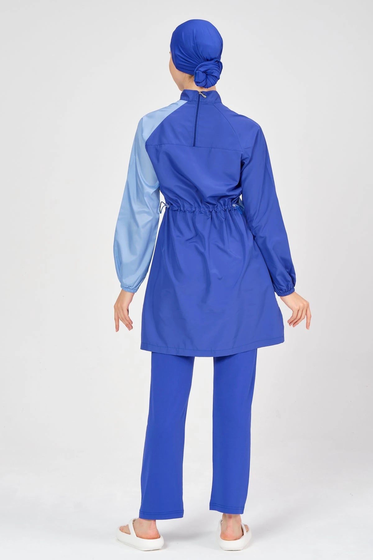Back view of blue modest swimsuit showing adjustable drawstring detail.