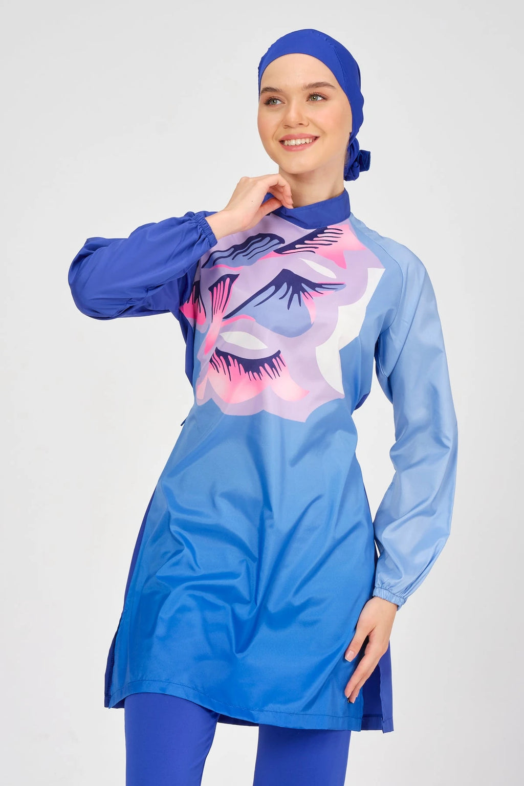 Close-up of blue modest swimsuit top with abstract print and collar.