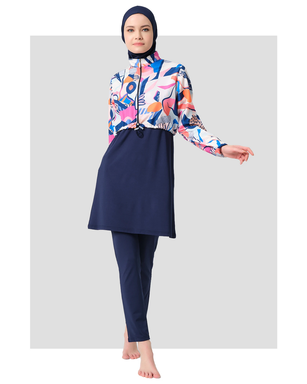 Woman in vibrant abstract print hijab swimwear set front view.