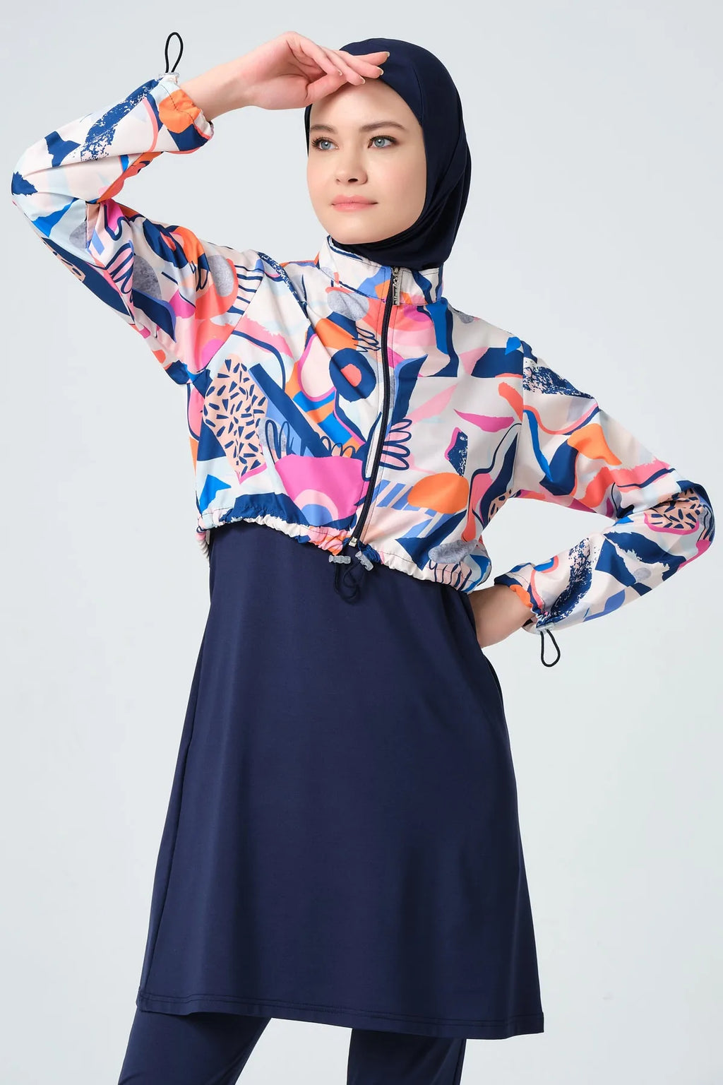 Close-up of woman in vibrant abstract print hijab swimwear.