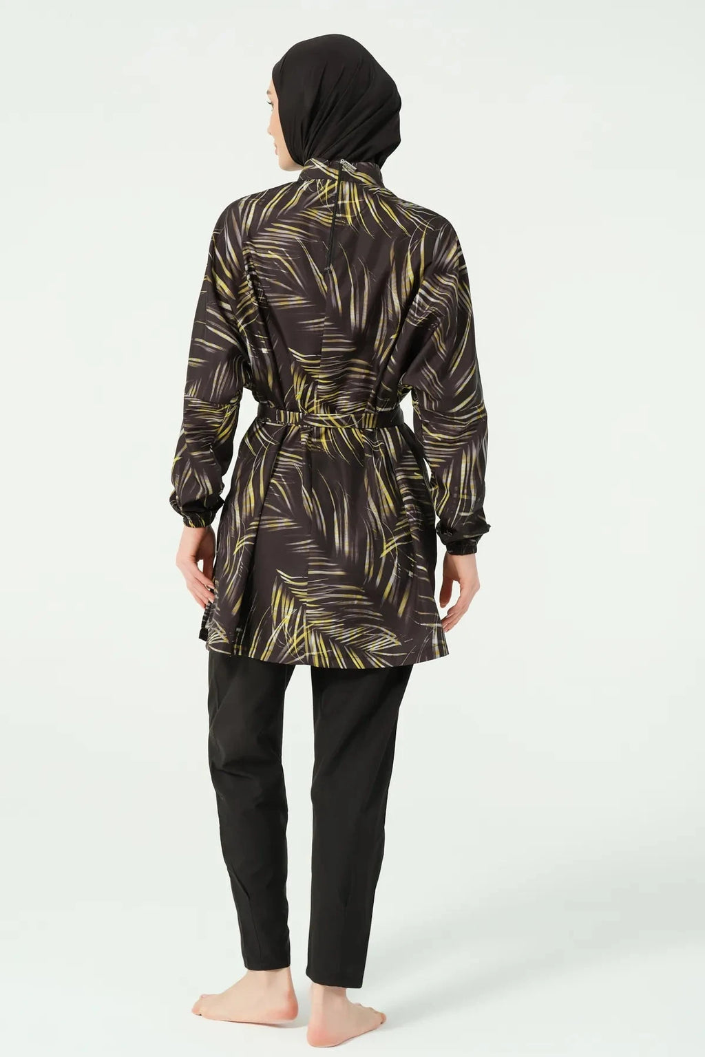 Black tropical print burkini with belted tunic, back view on model.