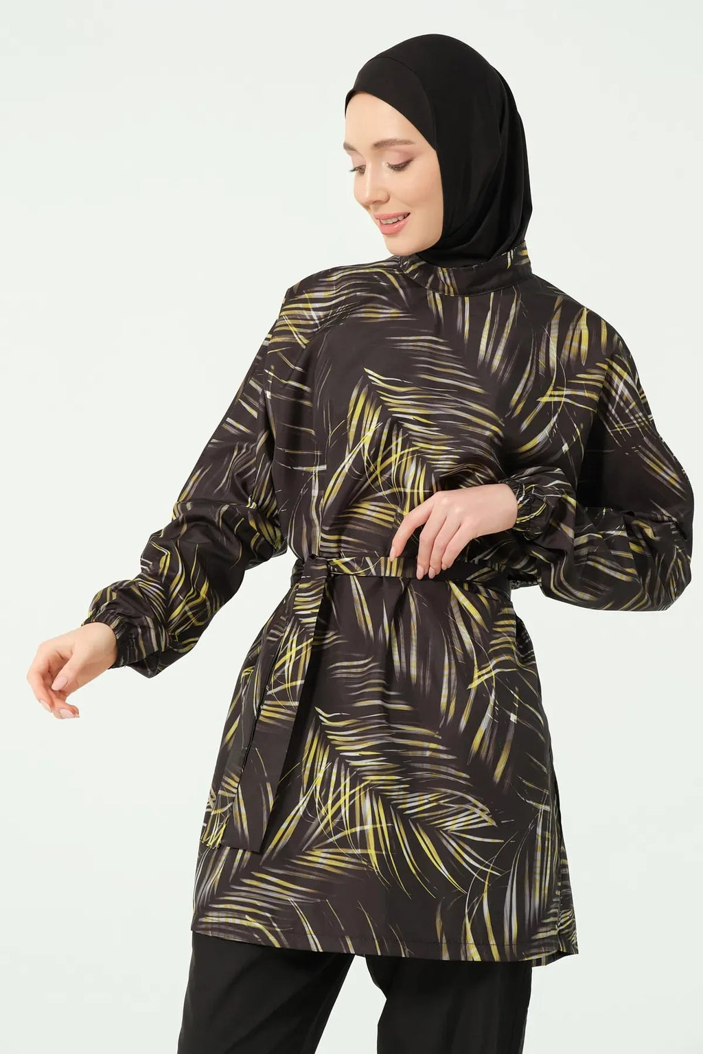 Close-up of black tropical print burkini showing balloon sleeves and print.