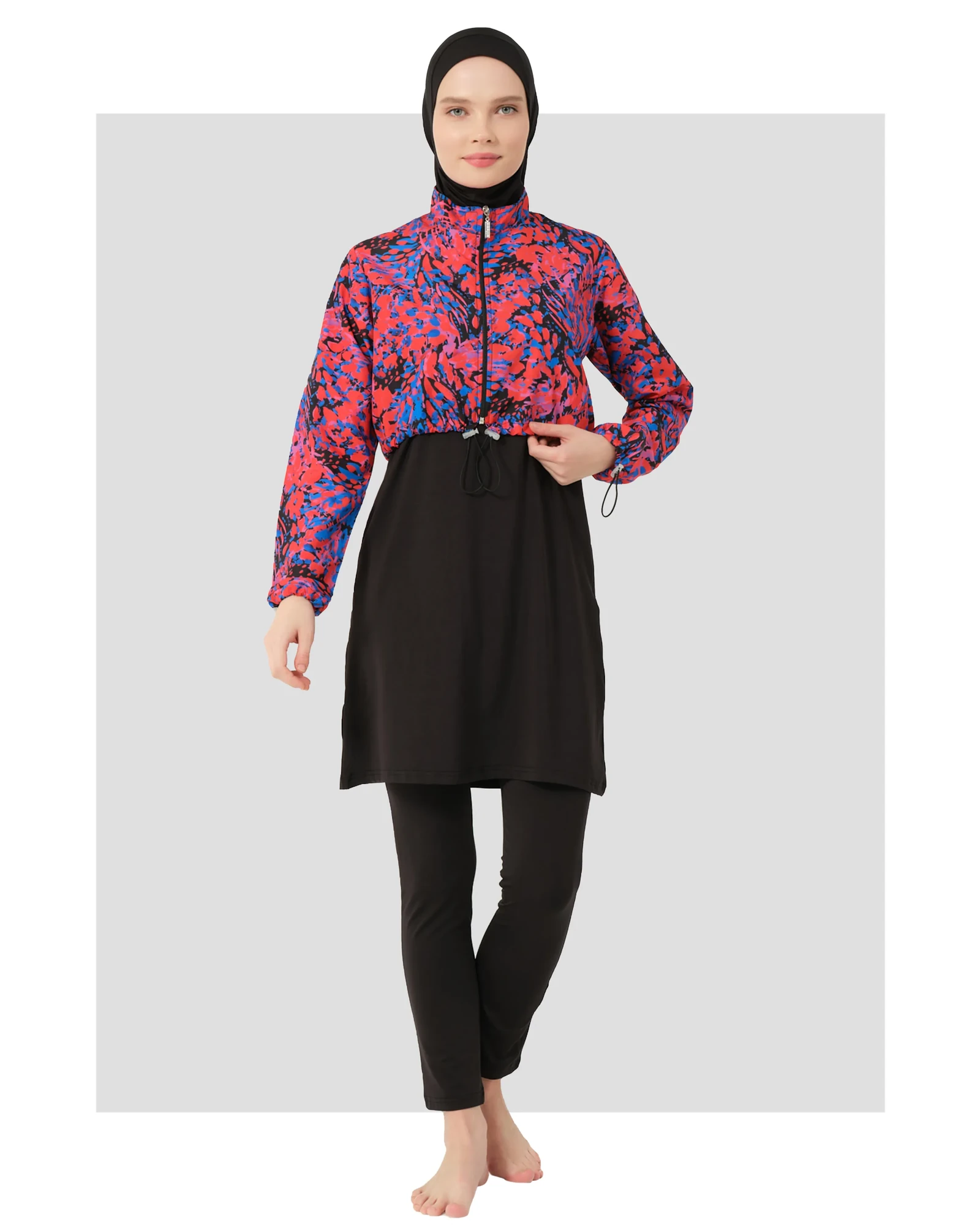 Woman in black hijab swimwear with abstract print jacket, front view.