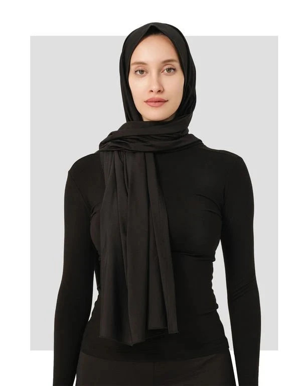 Black swim hijab with a secure fit and draped scarf on a woman.