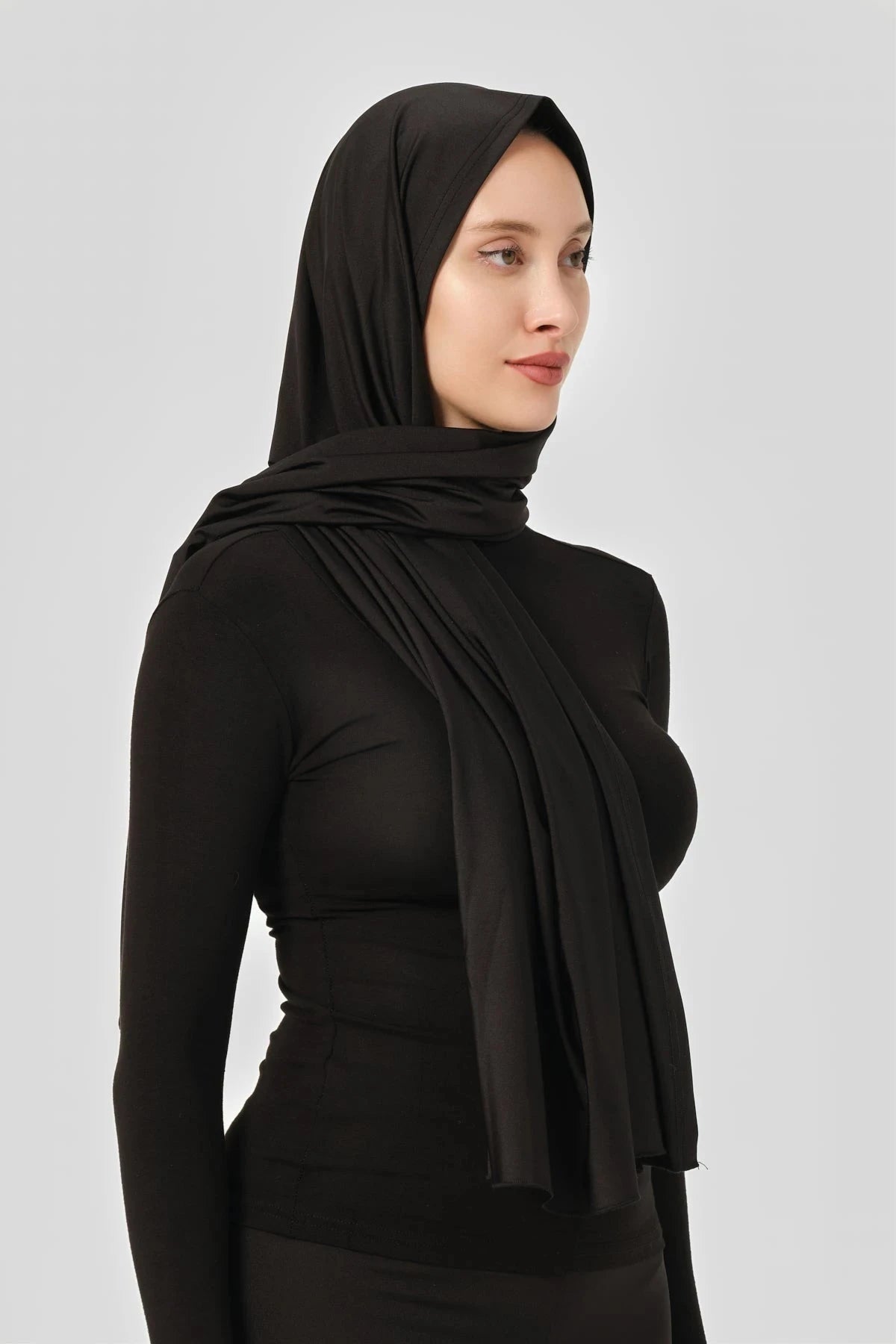 Black swim hijab with draped scarf shown from the side.
