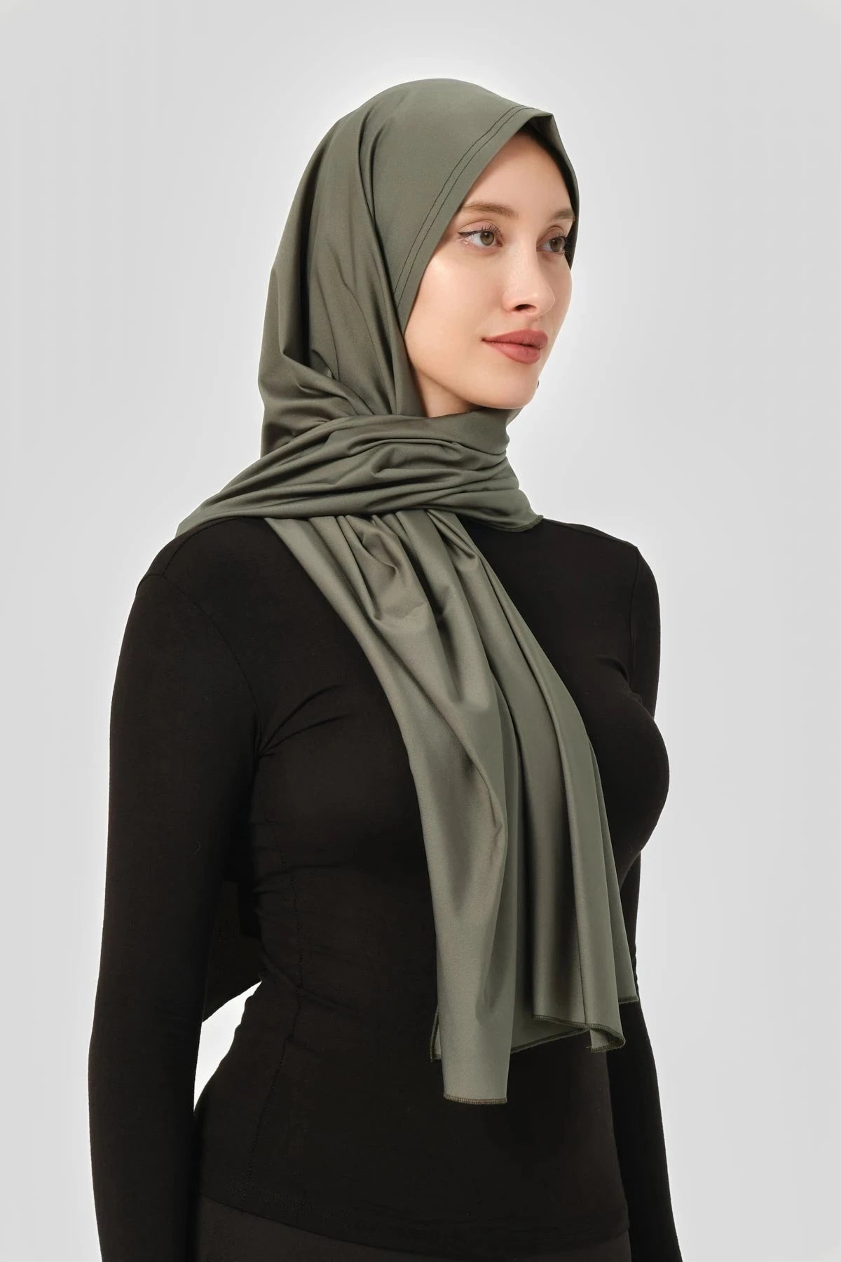 Olive green swim hijab with secure fit, showing draped fabric side view.