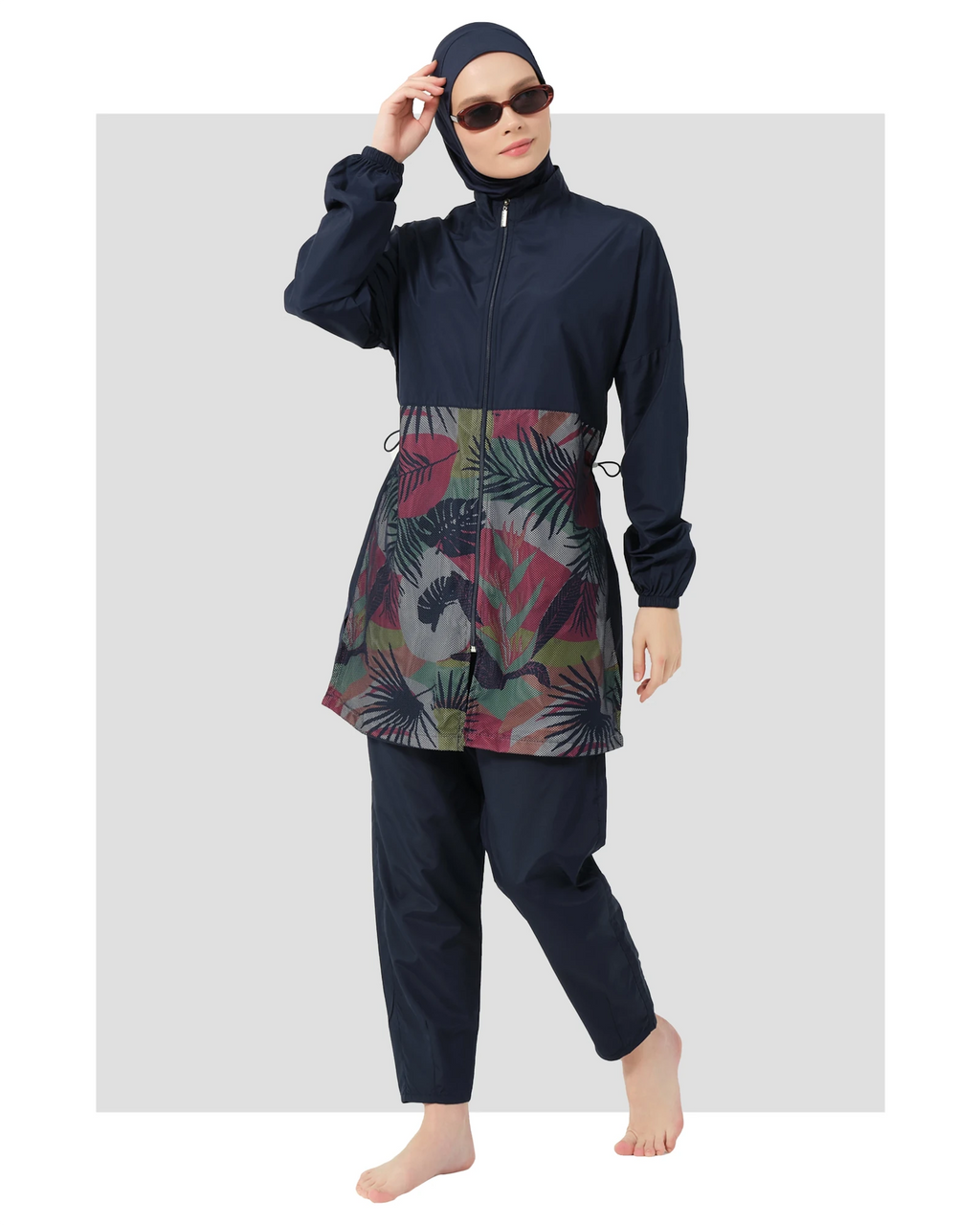 Navy burkini set with geometric print top and sunglasses, front view.