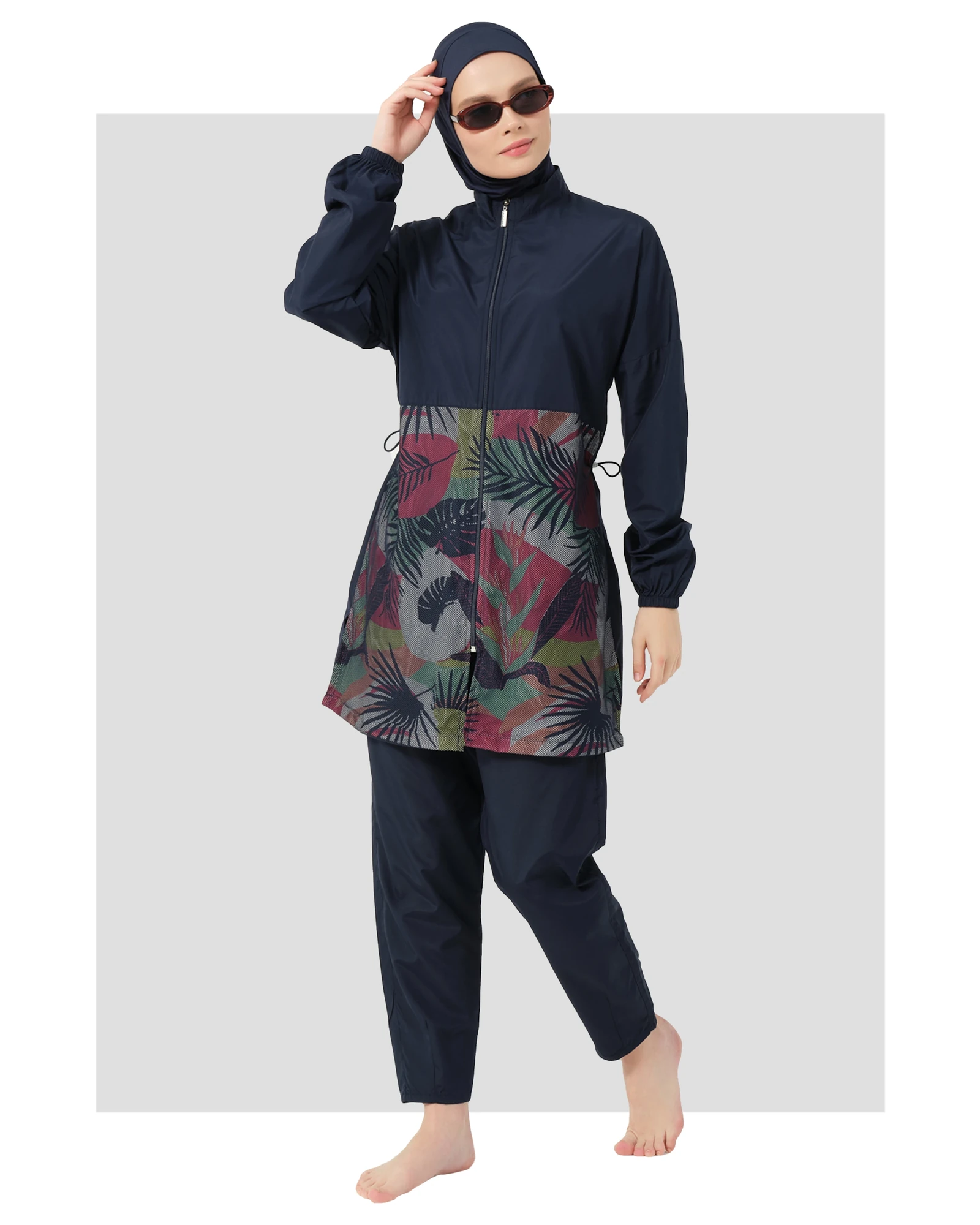 Navy burkini set with geometric print top and sunglasses, front view.