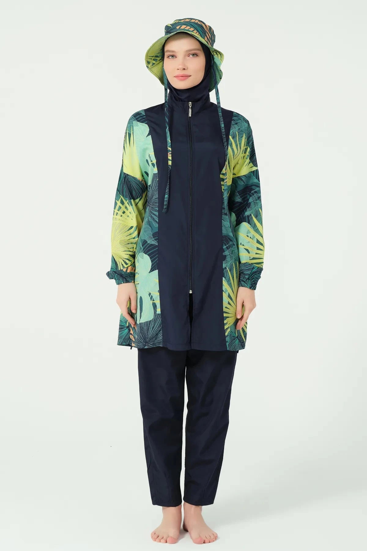 Model in tropical green burkini set with matching bucket hat, full front view.