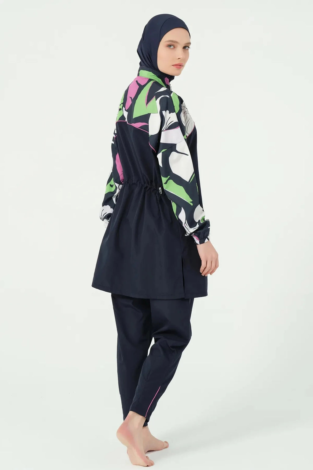 Back right side view of navy blue burkini with abstract floral print.