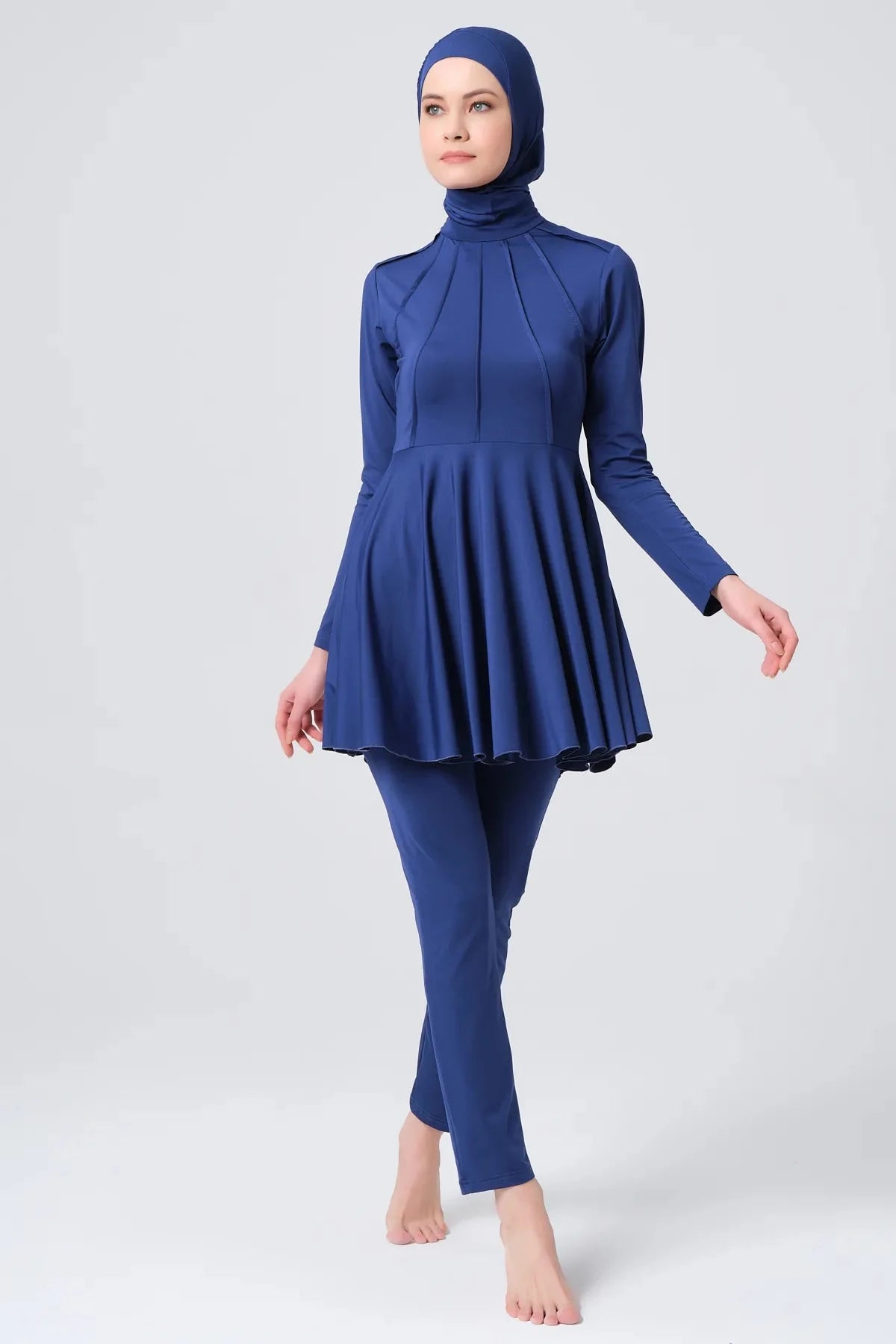 Dark blue modest swimwear set front view walking pose.