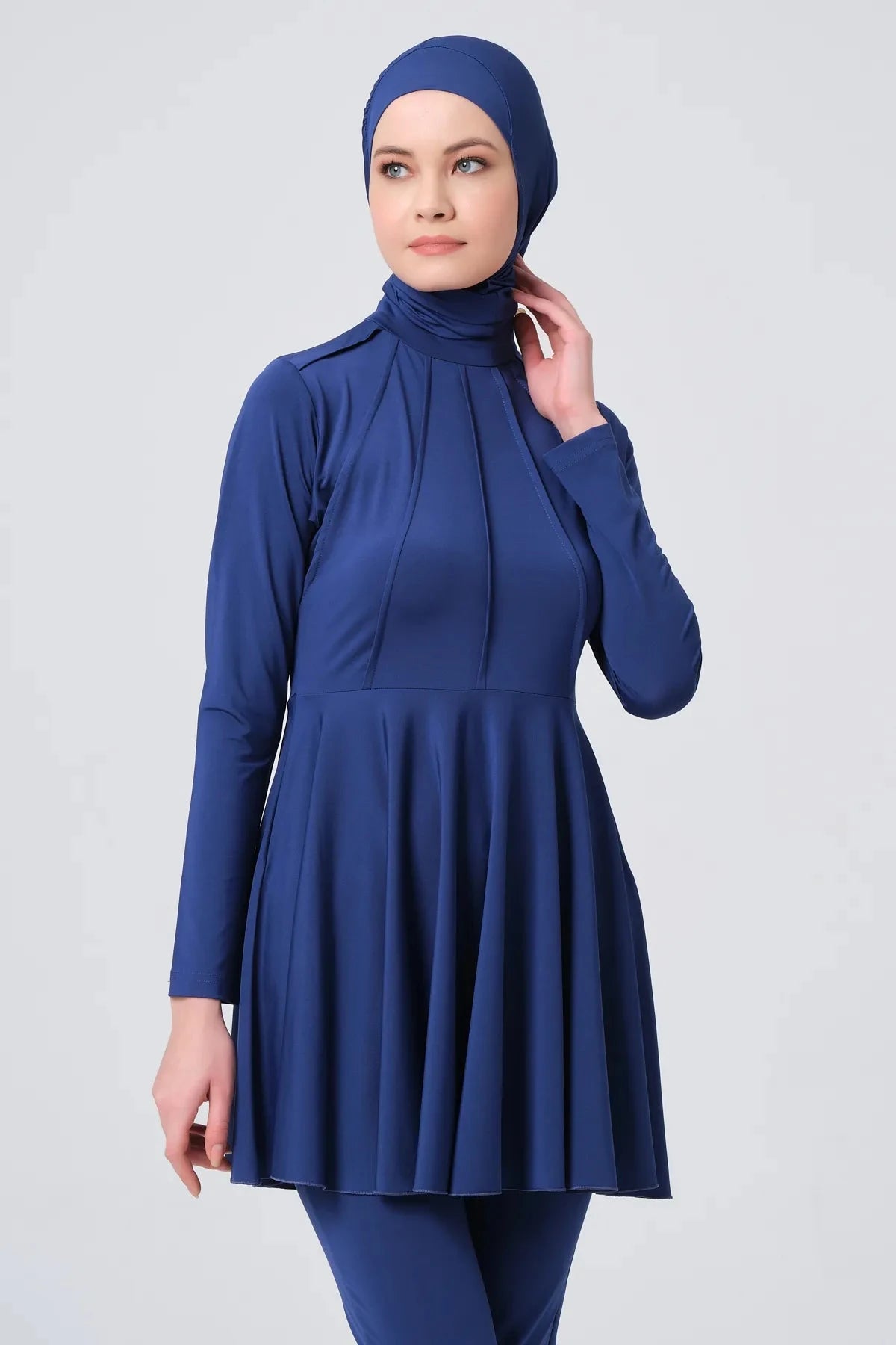 Dark blue modest swimwear top showing high neck and pleat details.