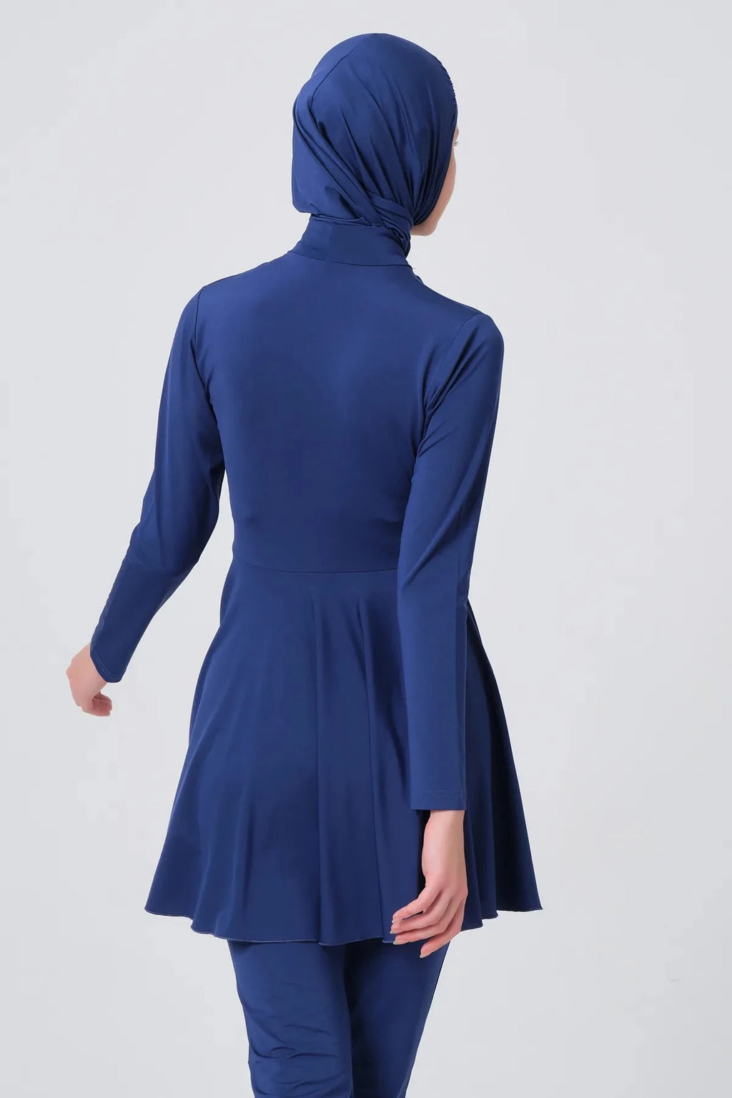 Dark blue modest swimwear set back view looking over shoulder.