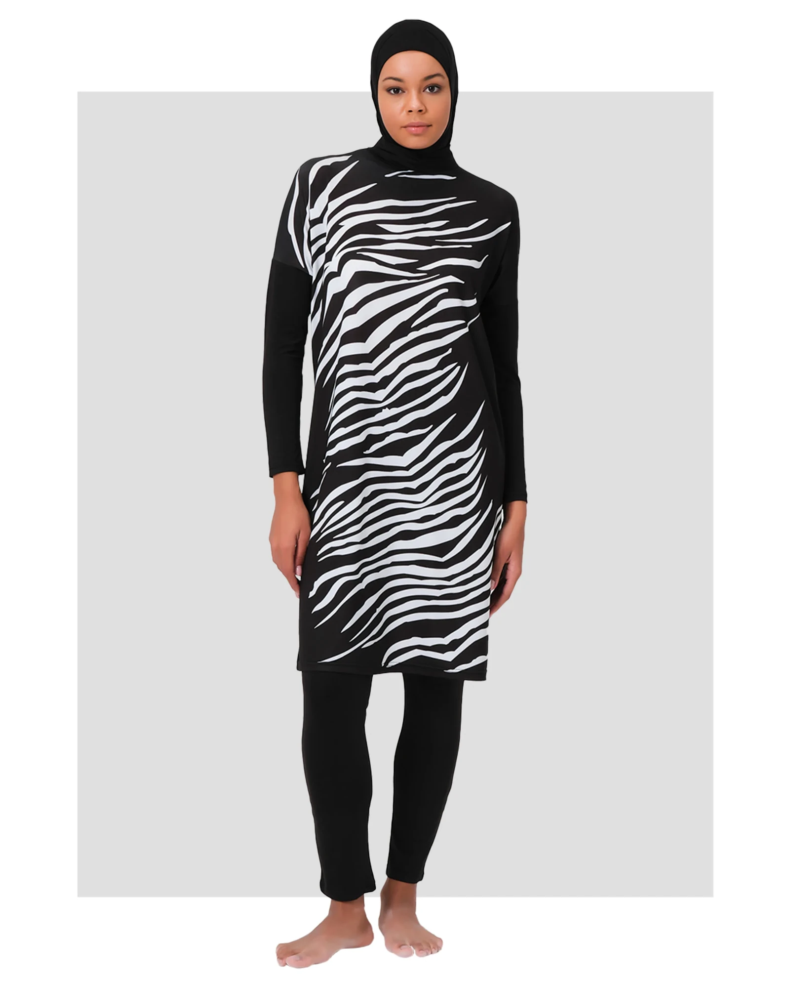 Woman wearing black and white zebra print burkini front view.