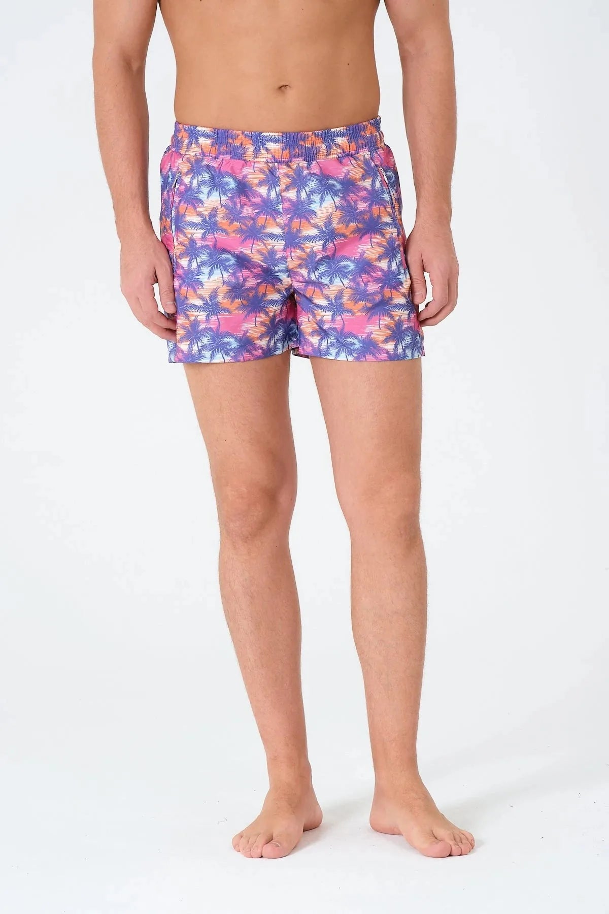 Men's swim trunks with palm tree print, front view.