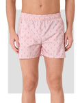 Pink men's swim trunks with flamingo print, front view.