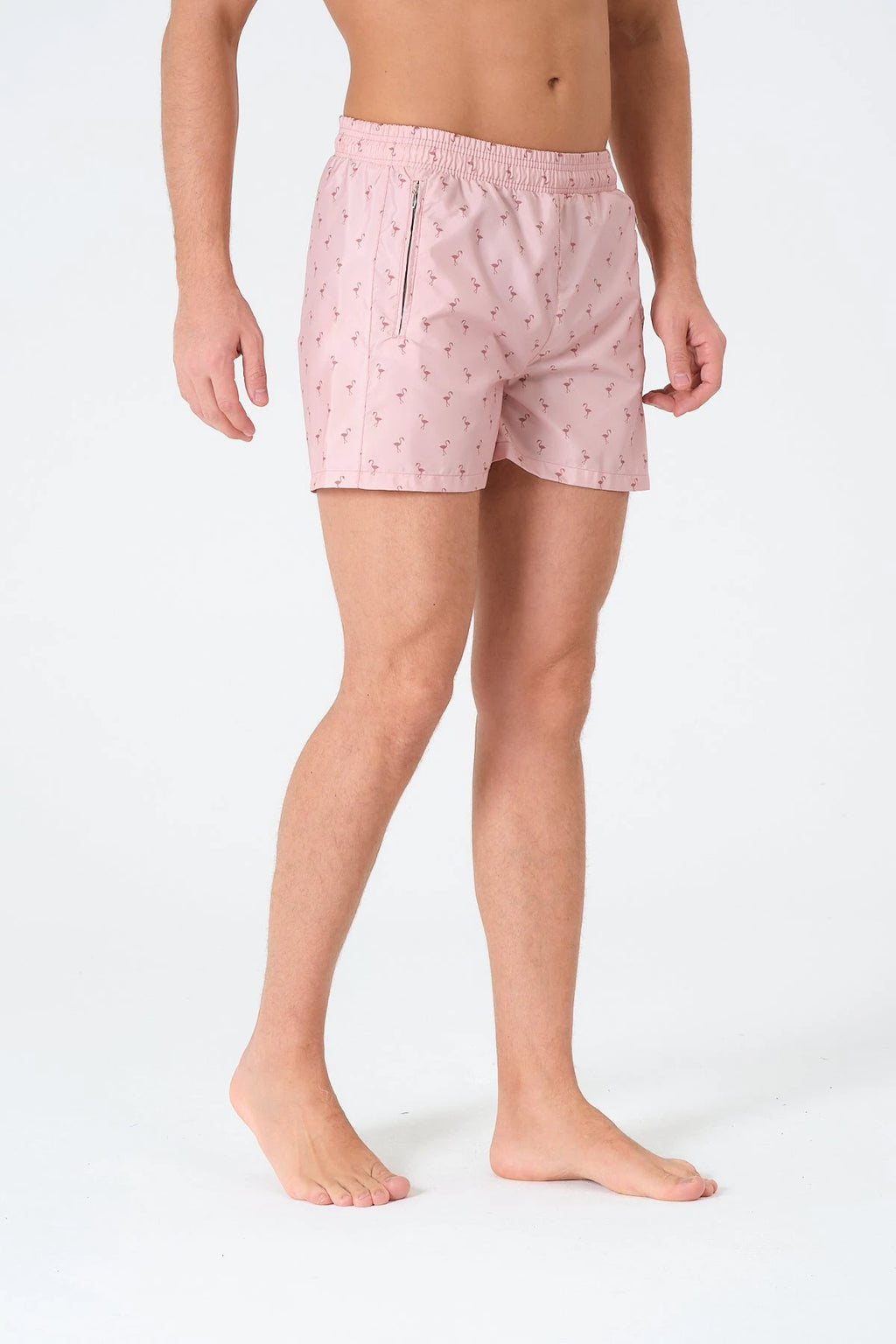 Another side view of men's pink flamingo print swim trunks.