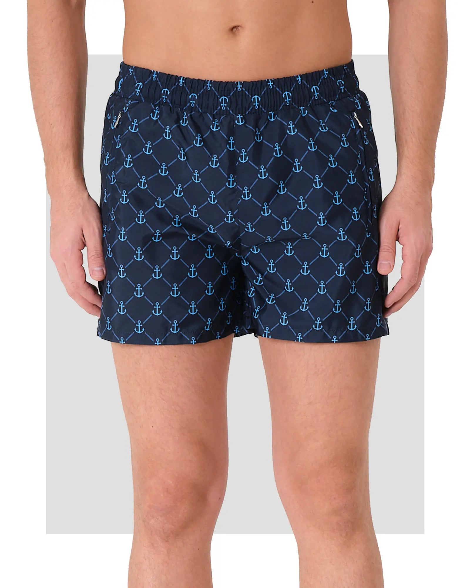 Navy blue men's swim trunks with anchor print, front view.