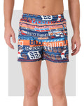 Men's swim trunks with sailing print, front view on white background.