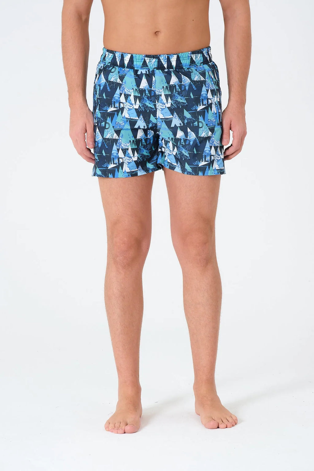 Close-up front view of men's blue swim trunks with mountain print pattern.