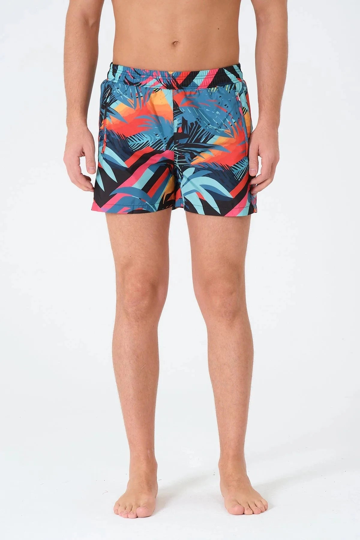 Men's tropical geometric print swim trunks front view.