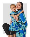 Blue abstract print burkini dress with flutter sleeves worn by a child, next to a woman.