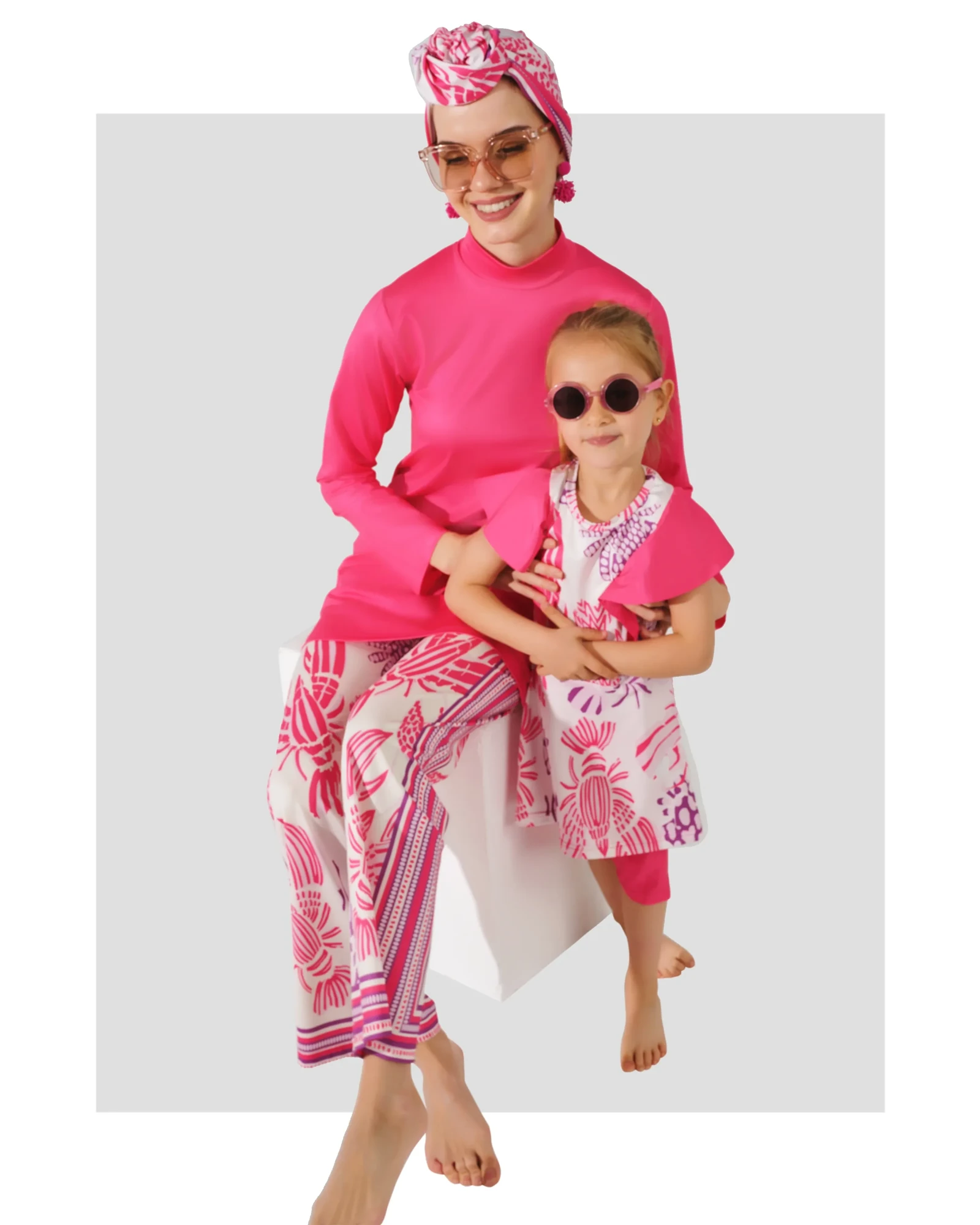 Mother and daughter in matching pink floral print modest swimwear