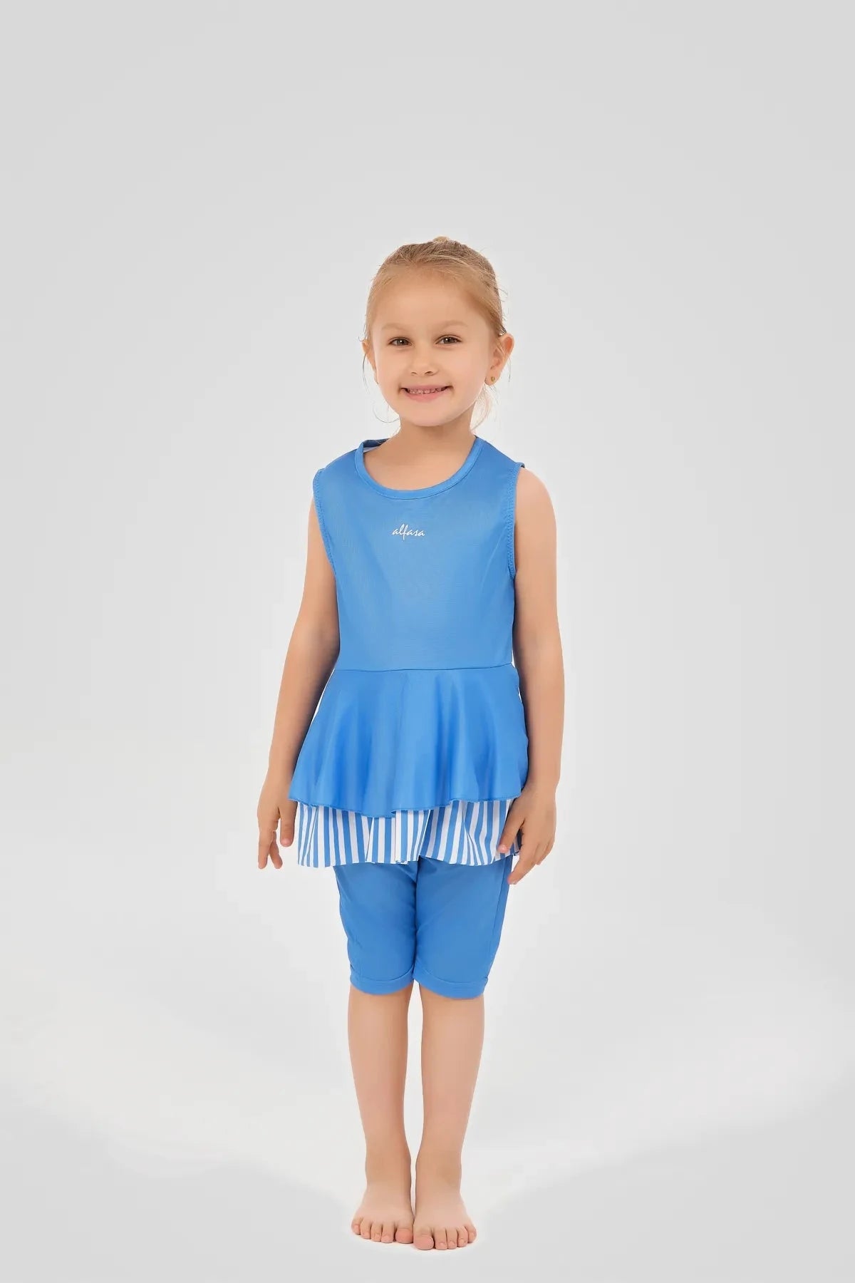 Full body view of a girl in a blue striped modest swim dress.