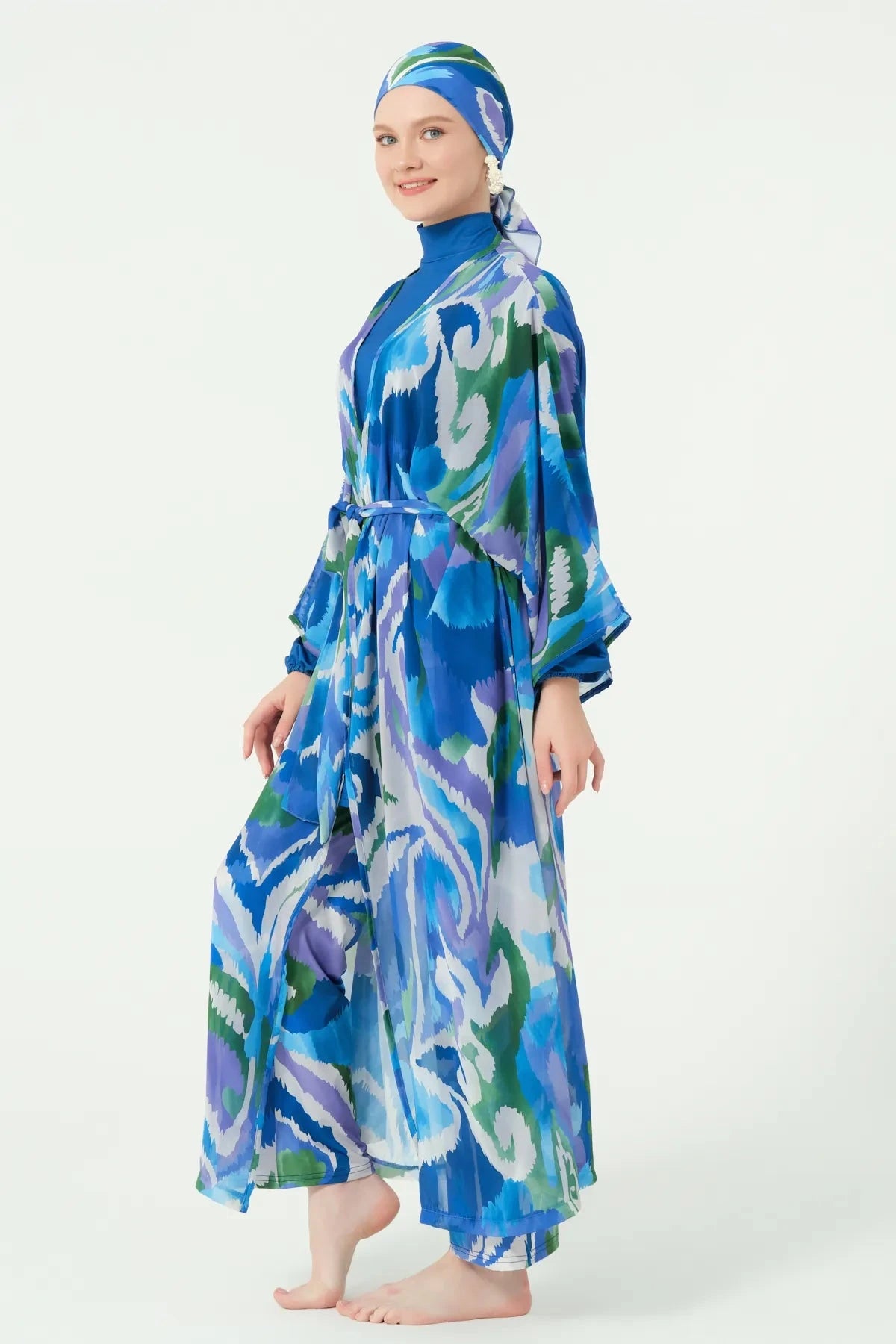 Model in deep azure sheer kimono with abstract print, side view.