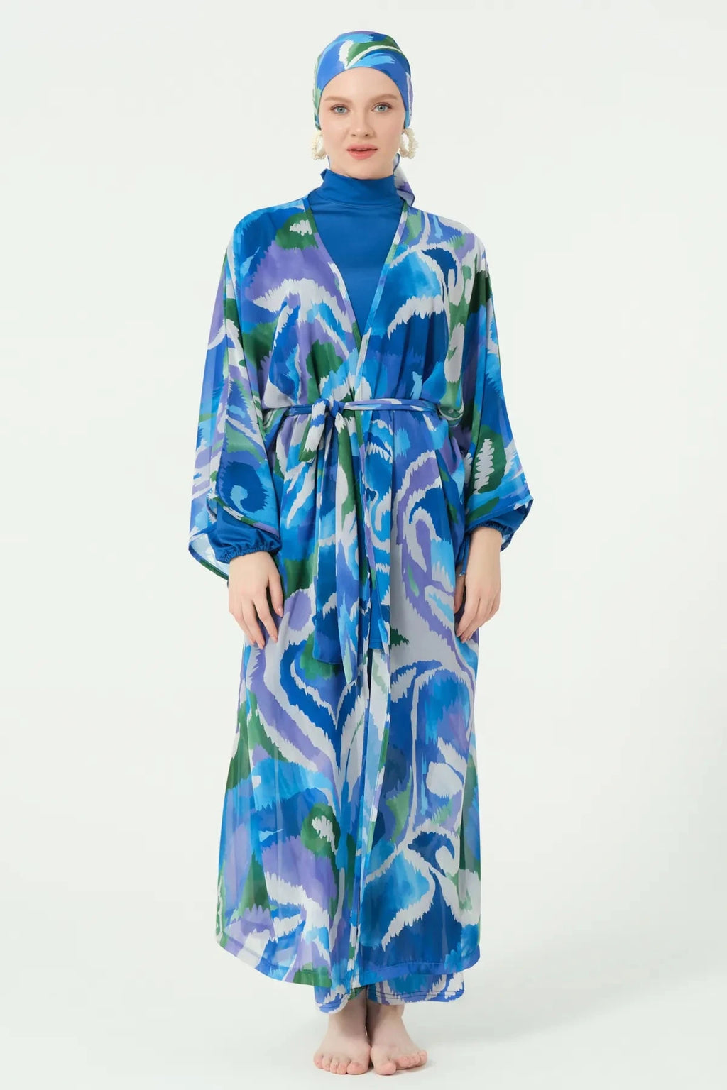 Model in deep azure sheer kimono with abstract print, full front view.