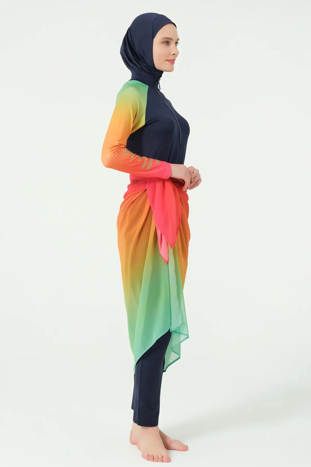 Model in gradient sarong over navy modest swimwear, full profile.