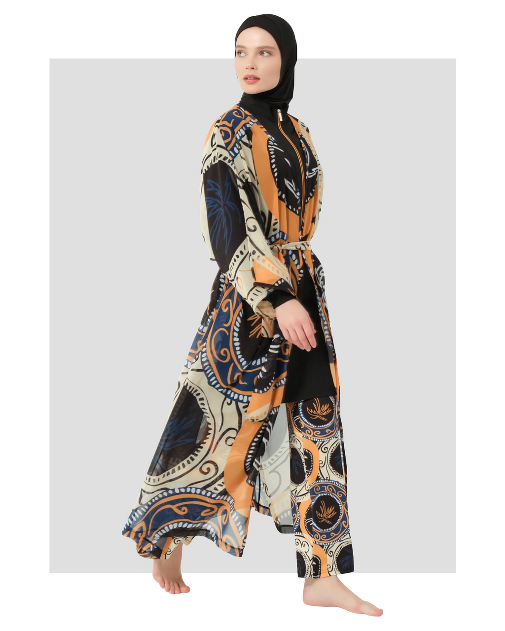 Model wearing abstract print sheer kimono with tie belt, side view.