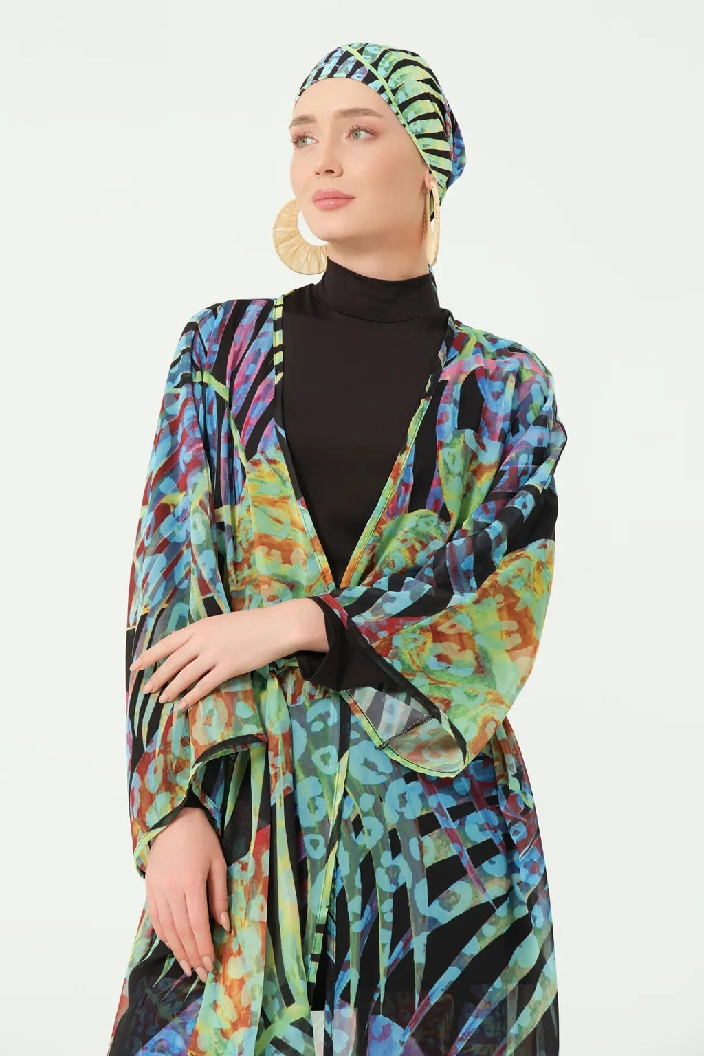 Close-up of model wearing multi-color sheer kimono and black high-neck swimsuit.