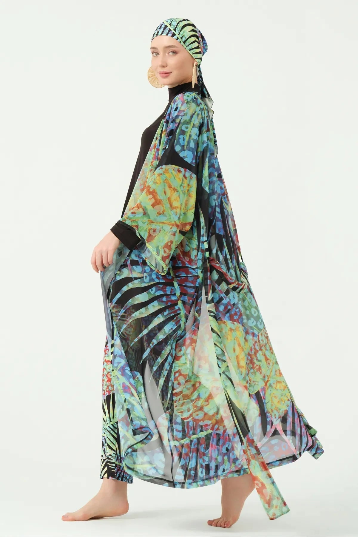 Model walking in multi-color sheer kimono, showing full length and flow.