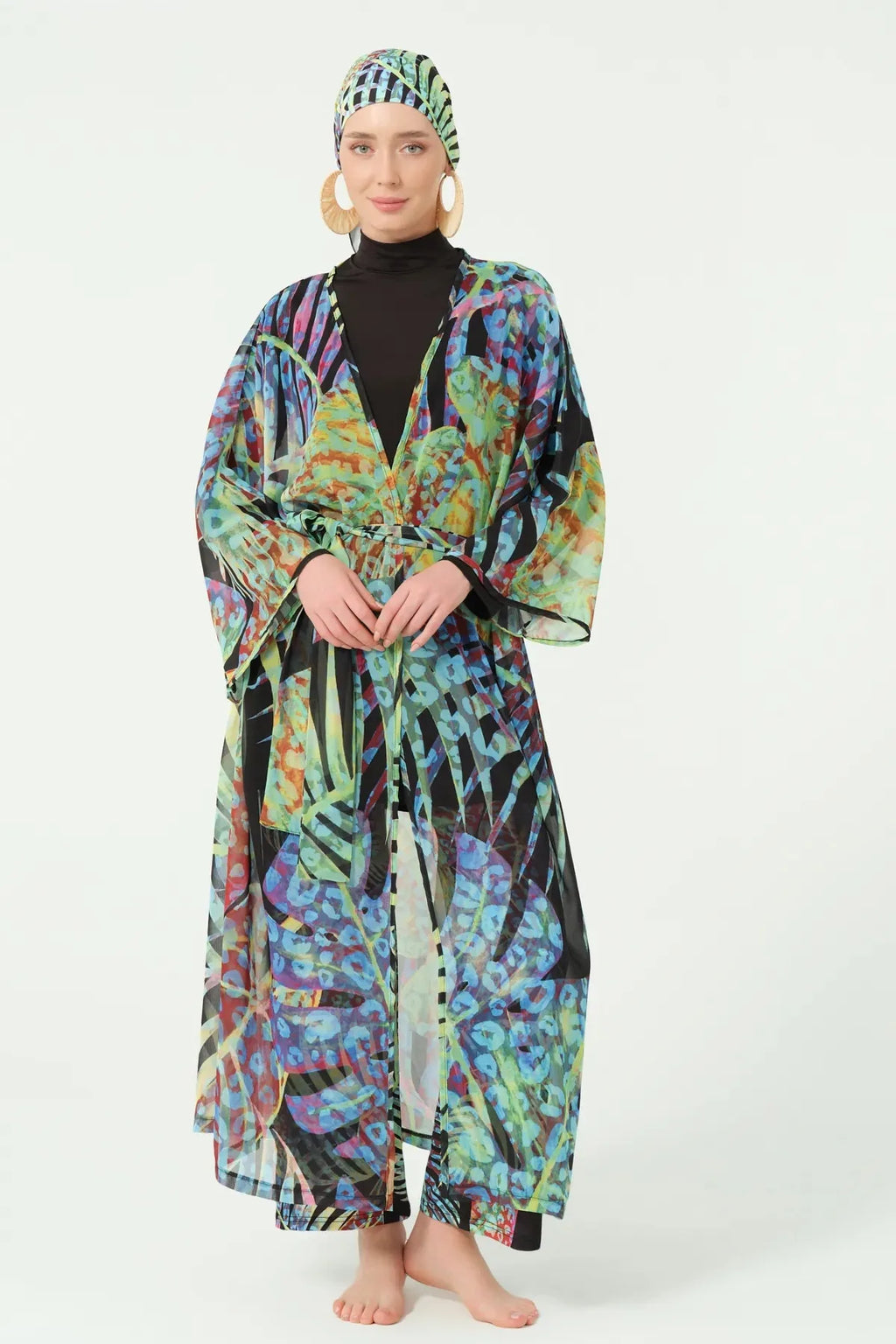 Front view of model in multi-color sheer kimono with hands clasped.